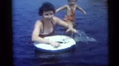Camden New Jersey USA (1959): A Lady And Her Child Swimming In The Ocean