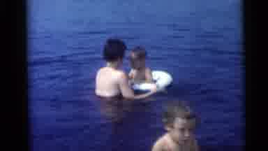 Camden New Jersey USA (1959): Woman Up To Shoulders In Water Cares For Toddler In