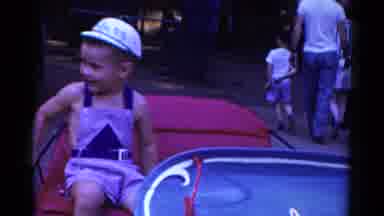 Catskill New York USA (1959): A Little Boy And Girl Sit Down On A Ride With