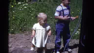 Catskill New York USA (1959): Baby Grabbing Onto Older Brother While Playing