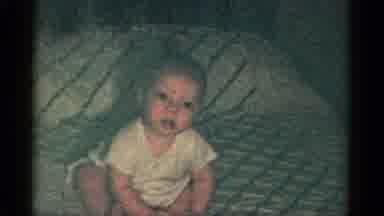 Catskill New York USA (1959): Baby Boy Sitting In The Bed While Laughing At