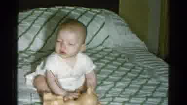 Catskill New York USA (1959): A Child Is Play In The Home On The Bed