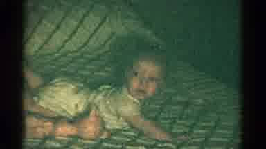 CATSKILL NEW YORK USA-1959: Baby Boy Lying on Belly on Striped Bed