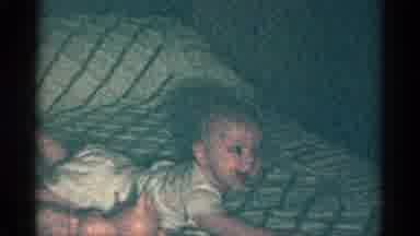 Catskill New York USA (1959): A Baby On A Bed Lifts Their Head Up And Looks Around