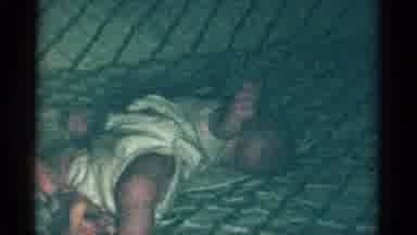 Catskill New York USA (1959): A Baby Being Held And Then Placed On A Bed To Squirm