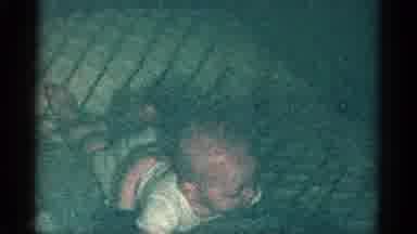 Catskill New York USA (1959): Infant Lying On A Bed On Its Stomach While Kicking
