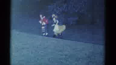 Catskill New York USA-1959: Two Costumed Characters Walking on a Grass Path
