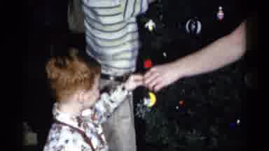 Catskill New York USA (1959): Children Decorate A Christmas Tree And Together Look