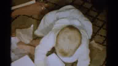CATSKILL NEW YORK USA-1959: Baby Crawls On The Floor And Plays With Boxes And