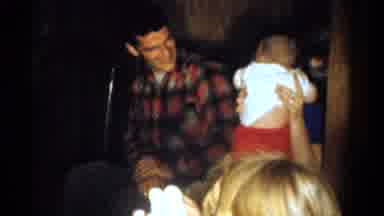 Catskill New York USA (1959): Couple Sitting Down While The Mother Is Carrying Her