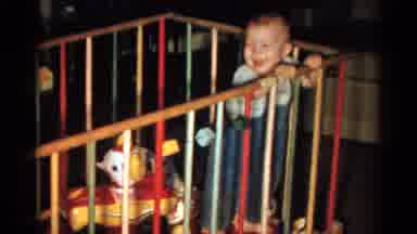 Catskill New York USA (1959): A Baby Straddles Up And Down A Crib