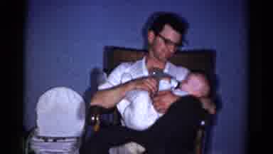 Catskill New York USA (1959): A Father Feeding A Little Boy Sitting On Chair