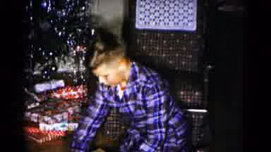 Hagerstown Maryland USA (1959): Young Boy Unwrapping A Large Christmas Gift With