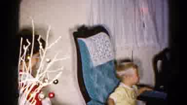Hagerstown Maryland USA (1959): Boy Wearing Yellow Shirt Rocks In Blue Chair While