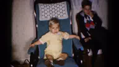 Hagerstown Maryland USA (1959): Little Boy Sitting In Rocking Chair While Others