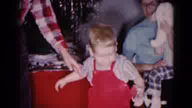 Hagerstown Maryland USA (1959): Boy Helps Toddler Wearing Red Overalls Stand For