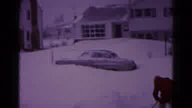 Hagerstown Maryland USA (1959): Man Shoveling Snow By Grey Car On A Clear Winter