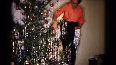 Hagerstown Maryland USA (1959): A Person Hangs Garland On A Decorated Christmas