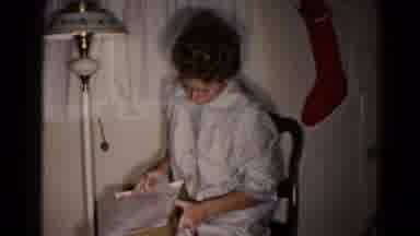 Hagerstown Maryland USA (1959): Woman Wearing Pajamas Sitting In A Chair Happily
