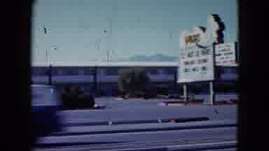 Nevada USA (1959): Cars Driving Down A Road With A Motel On The Side For Them To