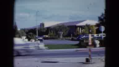 Nevada USA (1959): Cars Passing By At High Speed In Urban Area With Diner-Like