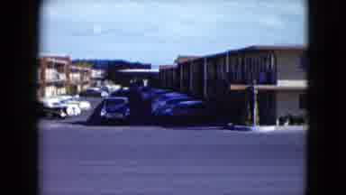 Nevada USA (1959): Truck Driving Past A Hotel Parking Lot In The Afternoon