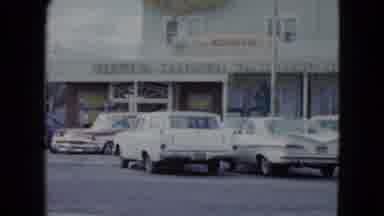 Nevada USA (1959): Passing By Cars Parked In Front Of Local Stores And A Nice