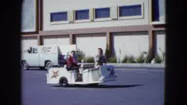 Nevada USA (1959): Two Men Drive By On Small Trolley Waving To The Camera