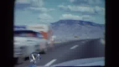 Nevada USA (1959): A Car Driving In A Desolate Environment Encounters A Car Coming