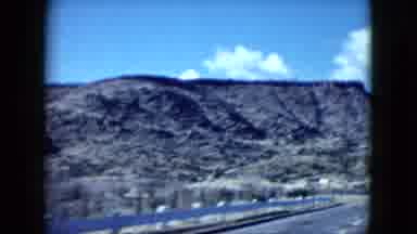 Nevada USA (1959): Passing View Of Mountain Desert And Blue Sky On A Sunny Day
