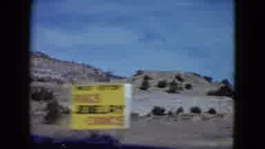 Nevada USA (1959): A Person In A Car Driving Past The Rocky Mountains