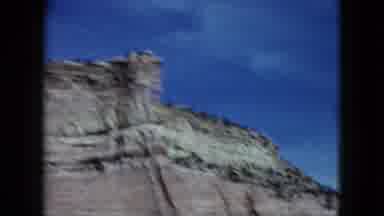Nevada USA (1959): View Of A Cliff Face And Two Yellow Signs From A Moving Car