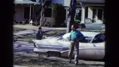 Nevada USA (1959): Man Walking On Grass Looking Back At Car Trunk Being Closed