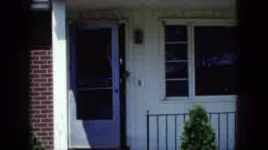 Nevada USA (1959): A Man Walking Outside His House And Playing With His Dog