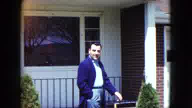 Nevada USA (1959): A White Man In A Dress Coat Walks In Front Of A Home With A