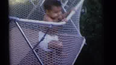 Camden New Jersey-1960: Baby Plays In Playpen While Other Sits In High Chair