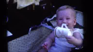 Camden New Jersey (1960): Baby With Food On Face Shakes Empty Cup In Stroller With