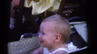 Camden New Jersey (1960): Baby Wearing White Shirt Looks At White Cup While