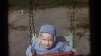 Camden New Jersey (1960): A Child Is Being Pushed On A Swing Set And He Looks Very
