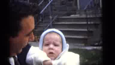 Camden New Jersey (1960): A Man In A Suite And Tie Holding A Baby