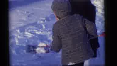 Camden New Jersey (1960): A Child In A Jacket Is Holding And Then Drops A Small
