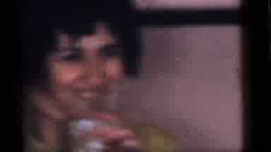 Camden New Jersey (1960): Woman Drinks From Glass While Kids Blow Party Favor