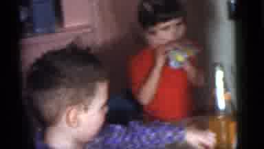 Camden New Jersey (1960): Girl Wearing Red Shirt Blows Blue Party Favor At Table