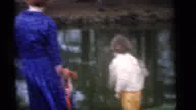 Camden New Jersey (1960): Woman Wearing Blue Dress Watches Person Wearing Black