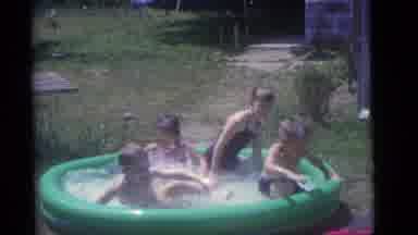 Camden New Jersey (1960): A Child Is Playing In The Garden With His Water