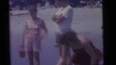 Camden New Jersey (1960): Woman Helps Toddler Splash In Water At Beach On A Sunny