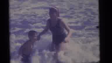 Camden New Jersey (1960): A Child Is Playing In The Garden With His Mother