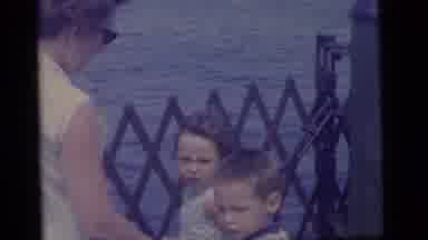 Camden New Jersey US (1960): A Mother And Her Children By Fencing On The Ocean