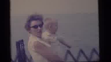 Camden New Jersey US (1960): Man And Woman Hold Toddlers While Looking At Ships On