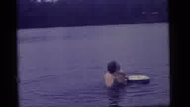 Camden New Jersey US (1960): Mother Holds Child And Floating Ring While Playing In